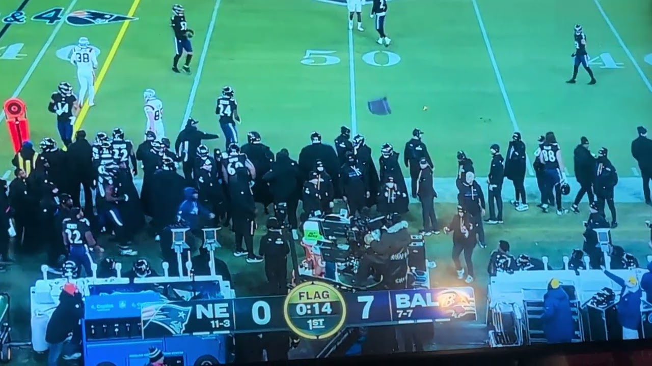 Baltimore Ravens player throws a towel in the air and it lands on someone's face. 