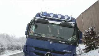 Spiegelglatte Fahrbahn - Winterdienst kaum zu sehen - Traktorfahrer zieht Lkw aus dem Graben