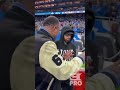 Eminem talks tactics with Barry Sanders at the NFL Playoffs, Detroit Lions game