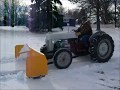 Old tractors moving snow