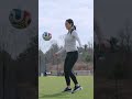 New England Revolution player Peyton Miller shows Nicole Gabe how pros dribble