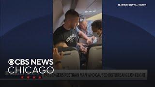 Passengers restrain man accused of trying to open exit door on Frontier flight to Chicago