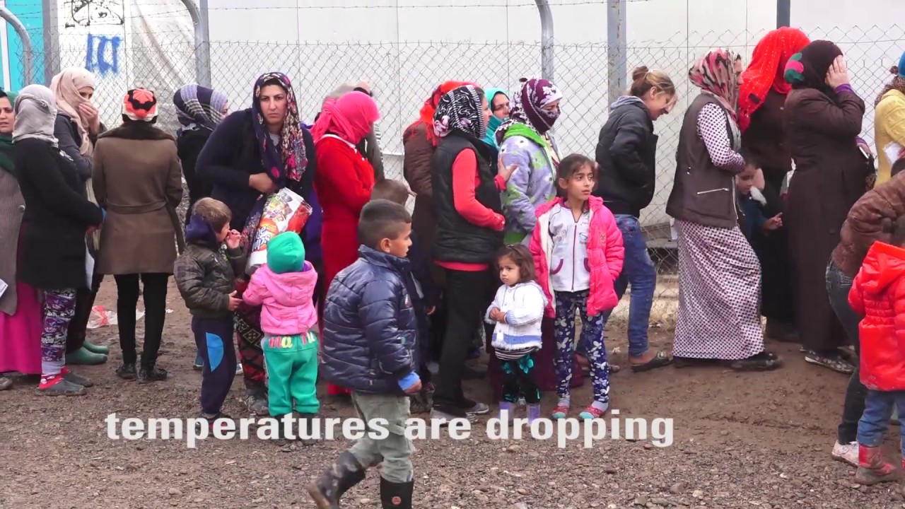 Warm for winter--children in Kawergosk camp receive clothes and boots.