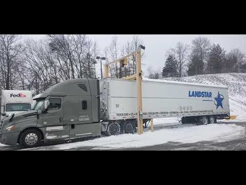 Snow scraper for truck trailer