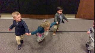 Kids run while holding hands and girl faceplants