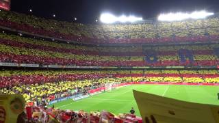 The crowd in stadium singing and creating a huge flag, oct 7, 2012
score at end of match between barcelona real madrid was 2-2. two
goals...