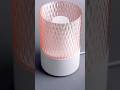 A minimalistic geometric lamp with a diamond pattern shade