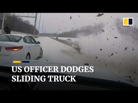 Moment quick-thinking US police officer dodges truck sliding down an icy highway