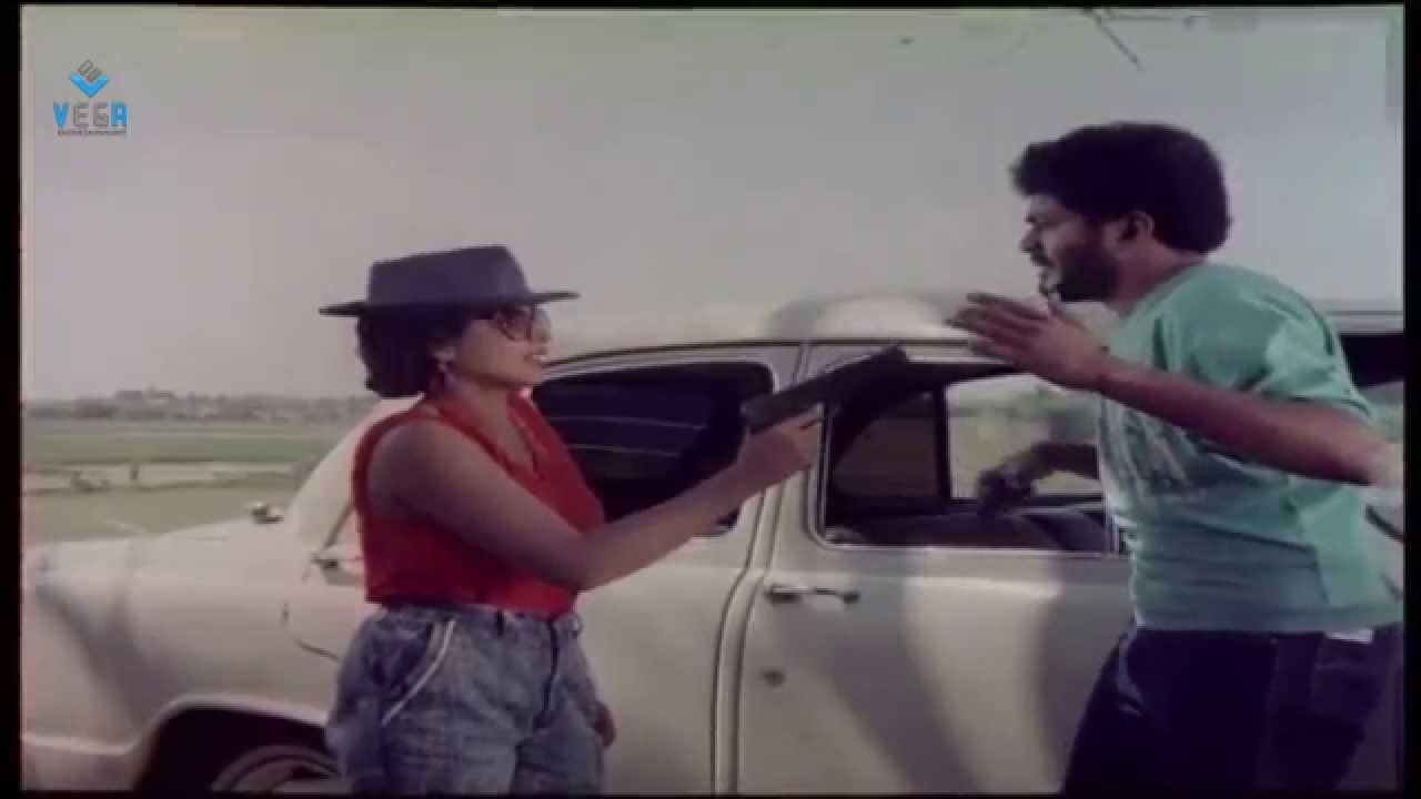 Athiradi Abhilasha Movie : Abilasha pointing a gun to rowdy Scene