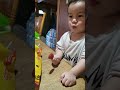 Luke eating a mango lollipop