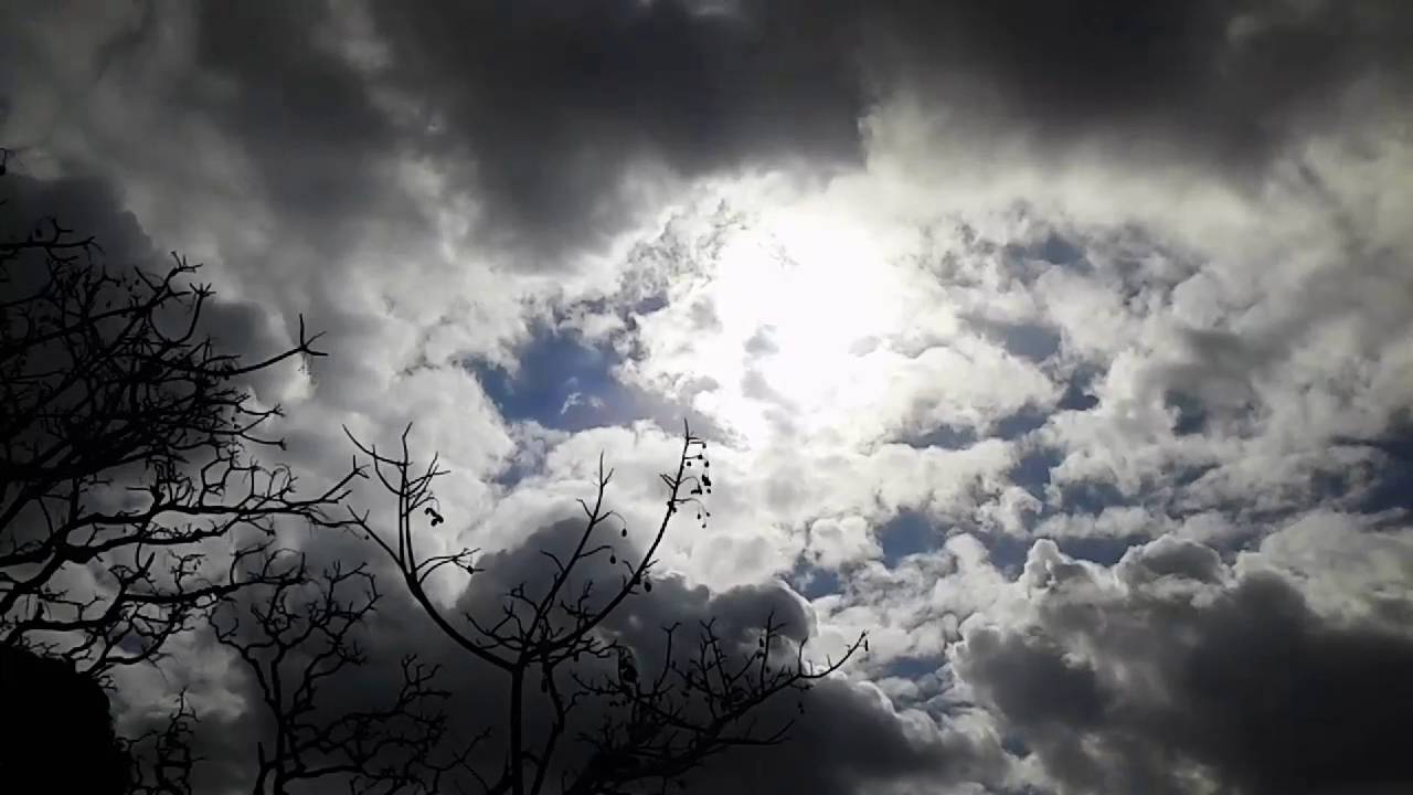 TIME LAPSE OF RAIN CLOUDS COVERING THE SUN. - YouTube