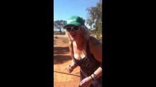 woman pats wild emu