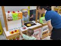 Baby cute and sister at indoor playground with toys and camp for kids