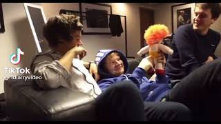 Harry Styles And Ed Sheeran Inspecting A Stuffed Ed Sheeran Doll Together