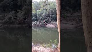 Guy swings on rope swing but doesn't let go and lands on sand