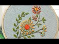 Hand embroidery of a flower motif with chain stitch and french knots