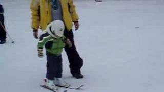 A 3 year old boy skiing