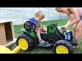 Melissa and baby Arthur unpack and assemble the tractor