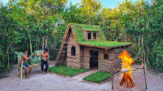 Building complete and warm survival shelter hut, grass roof