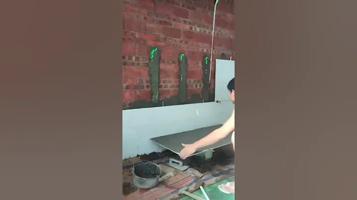 The process of laying tiles on a brick wall