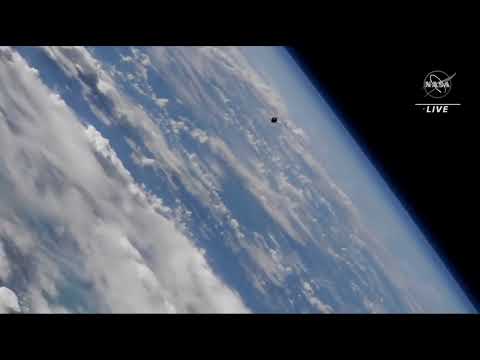 Crewed soyuz approaches space station in stunning over Earth view