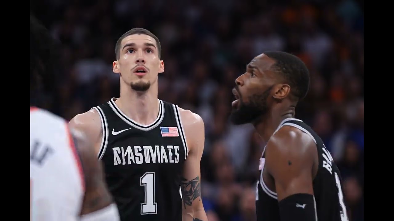 Two basketball players are looking up in the picture