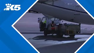 2 people found dead inside plane's landing gear