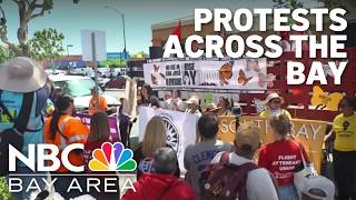 Demonstrators march for worker and immigrant rights in Bay Area May Day protests