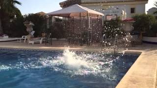 Slow motion spinning jump into swimming pool