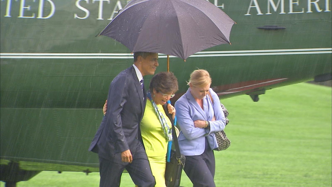 Boris Johnson struggles with umbrella at police memorial unveiling