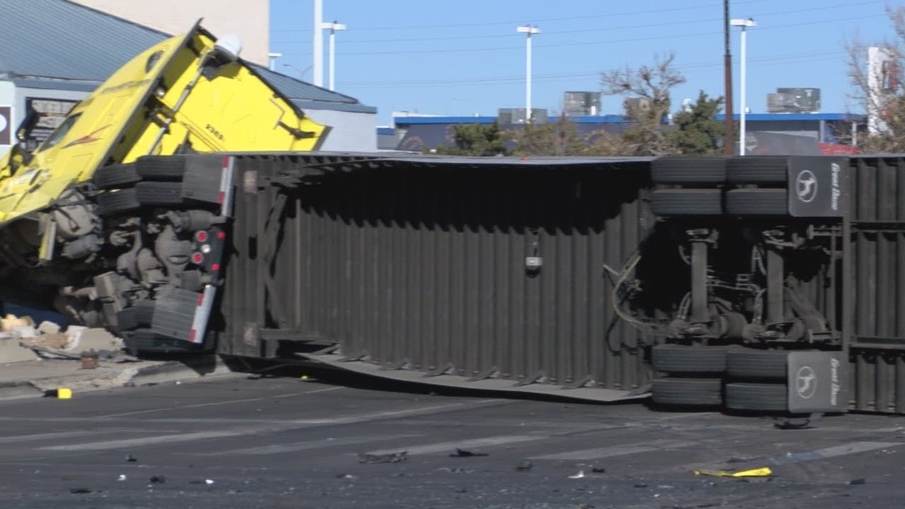 Rollover involving semi truck shuts down intersection of Menaul and ...