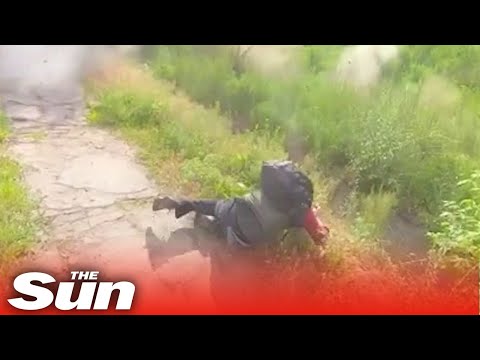 Journalists dive for cover just in time as Russian shell explodes in Luhansk.