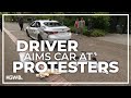 Driver rolls toward protesters on portland state university camps launching pepper spray