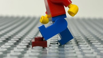 LEGO Man steps on a LEGO brick