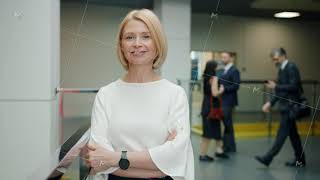 Portrait of cheerful mature woman standing in office hall smiling looking at camera Portrait of cheerful mature woman standing in office hall smiling looking at camera