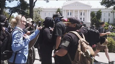 Groups at the California State Capitol clash while...