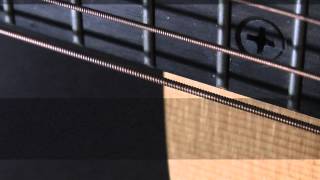 Close up view of guitar string vibrations using a stobe light.