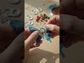 Hands building butterfly from tabs