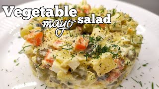 Tasty vegetables mayonnaise salad with pickled cucumbers