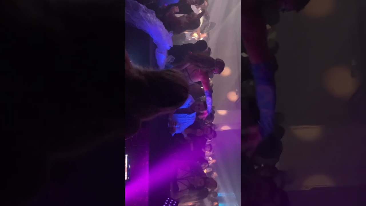 Lots of people having fun in the Dj booth and on stage.