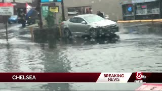 Cruiser pushes stalled SUV on flooded road