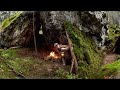 Building a shelter under a giant rock during heavy rain  cooking on hot stone