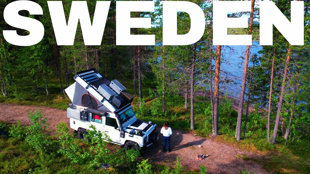 A White Land Rover Defender infront of a Lake in Sweden