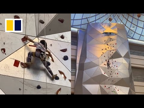 Fearless little Chinese girl climbs 50m wall in mall