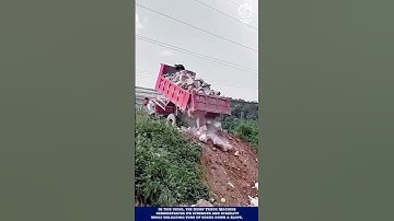 Heavy machine unloading tons of rocks down a slope