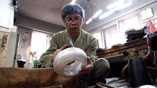 The process of making a silver teapot by hitting it tens of thousands of times. Korean craftsman