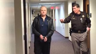 Shackled funeral director walks to court to face fraud charge