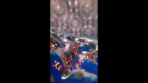 Extreme blue sideways closeup w metalic pink backg...