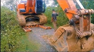 Here are the steps in English for loading and unloading an excavator onto a self-loader truck: