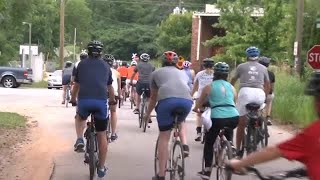 Community members gather for a memorial bike ride to honor the victim of a deadly hit-and-run